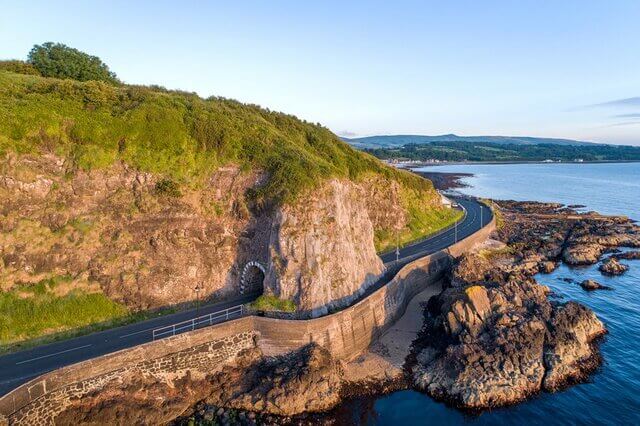 A road with a tunnel in the Causeway Coast, Northern Ireland