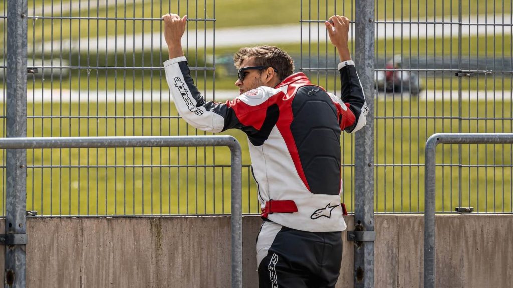 A rider wearing a white, red, and black protective jacket for added safety and style.