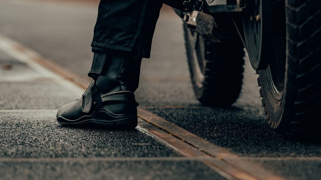 A rider wearing motorcycle boots designed for safety and comfort during rides.